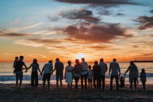 A group of people standing on a beach - Consider Gifting from Your Estate During Your Lifetime