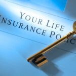 A key lying on a document - Considering Life Insurance? Ask Yourself These Questions First